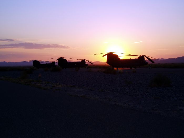 Gila Bend, Arizona, 2005: A sunrise backdrop with three Army National Guard Chinooks belonging to Company B, 3-238th General Support Aviation Battalion (GSAB), Greensburg, Ohio (CAK). Their mission: Operation Iron Cactus, South West Border Vehicle Barrier Placement.