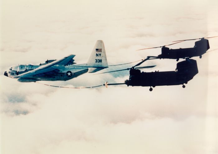 A pair of MH-47E models conducting in-flight refueling.