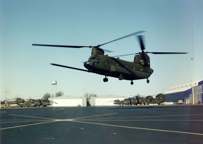 An MH-47E model Chinook helicopter hovering outside the Morton, Pennsylvania Chinook production facility.