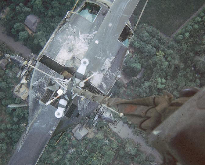 An all too familiar mission for Chinook helicopters in Vietnam was the recovery of downed aircraft. Shown above, 68-15817 back hauls a UH-1 Huey for repairs.