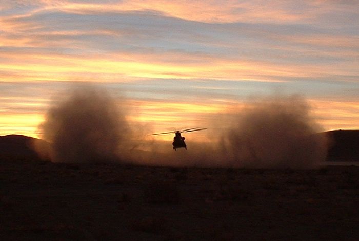 Chinook 82-23768 shaking off the dust at sunrise in NTC, January 2002.