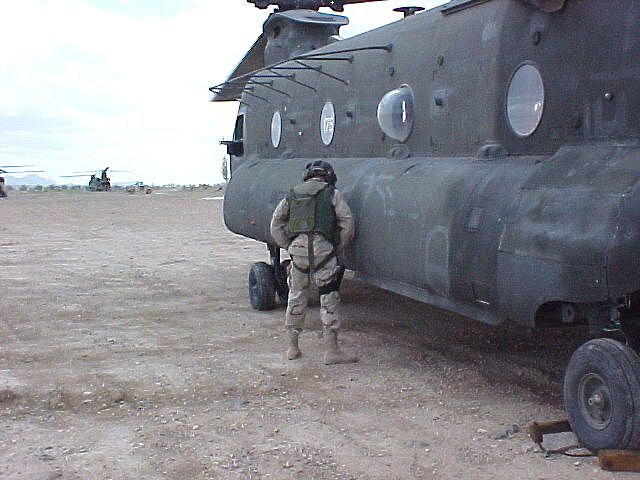 Checking for leaks on CH-47D Chinook helicopter 84-24175 at an undisclosed location in Afghanistan, late 2003.