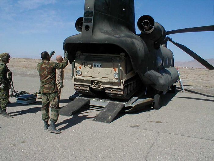 Canadian 3rd PPCLI soldiers practice conducting internal loading techniques utilizing U.S. Army CH-47D Chinook helicopter 86-01669, assigned to A Company, 7th Battalion, 101st Airborne Division, from Fort Campbell, Kentucky, in preparation for Operation Anaconda. The BV-206 tracked vehicle, at 7 tons (14,000 pounds), is easily carried by the CH-47D and is narrow enough to easily roll on and off its rear ramp.
