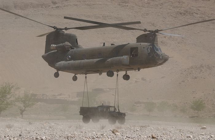 A HMMWV is sling loaded under CH-47D Chinook helicopter 91-00255 by soldiers from 2nd Battalion, 22nd Infantry Regiment to be transported to Kandahar Air Field, Afghanistan in the Uruzgan Province along the Tirin River during Operation Mountain Storm.