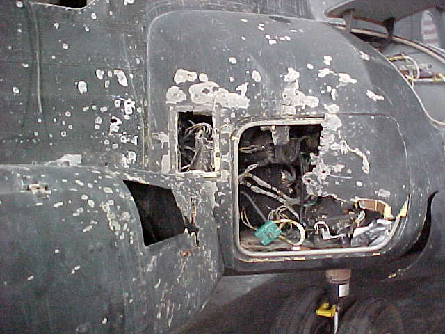 RPG damage to electrical pod, left side near cockpit.