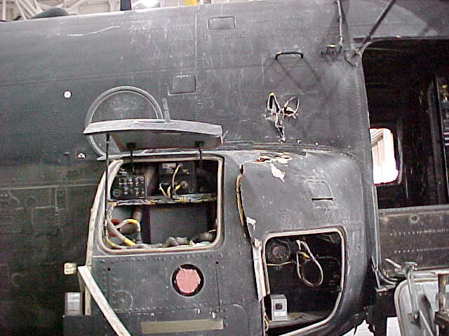 Damage to electrical pod by RPG, right side near cockpit.