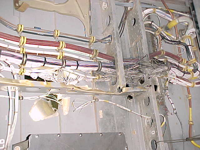 Inside view of damage to electrical pod by RPG, right side near cockpit.