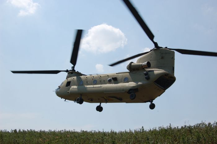 04-08702, a new CH-47F Chinook helicopter, flies over a training area on Fort Campbell, Kentucky, during the 15 August 2007 rollout of the upgraded aircraft.