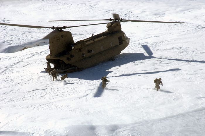 15 February 2009: U.S. Army soldiers from Alpha Company, 1st Platoon, Personnel Security Detail, 101st Airborne Division exit a CH-47 Chinook helicopter to provide security in Bagram, Afghanistan.