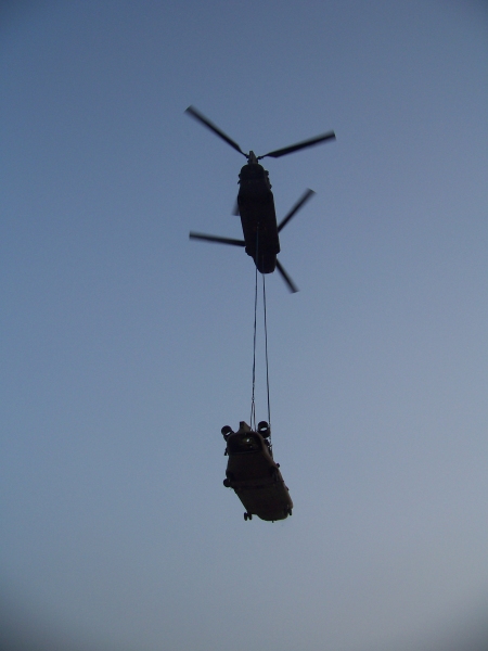 27 July 2010: The remains of 08-08048 airlifted from the crash site by the Downed Aircraft Recovery Team (DART) and courtesy of another Chinook helicopter - 87-00082.
