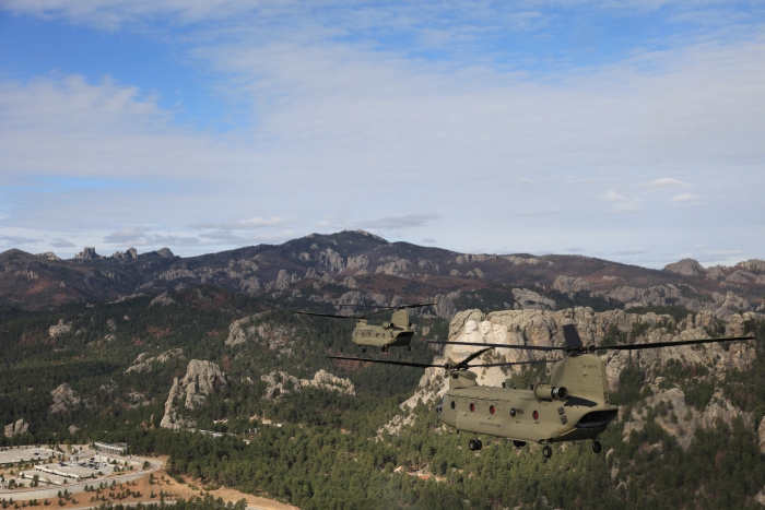 13 April 2012: CH-47F Chinook helicopter 08-08775 and 08-08772 are photographed from 08-08774 passing Mt. Rushmore, South Dakota.