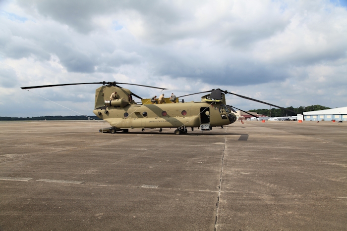 5 August 2013: CH-47F New Equipment Training Team (NETT) member "Z" Szumigala (center) conducts preflight training with his Army National Guard students while NETT Flight Engineer Chad Cox closes up the aft pylon.