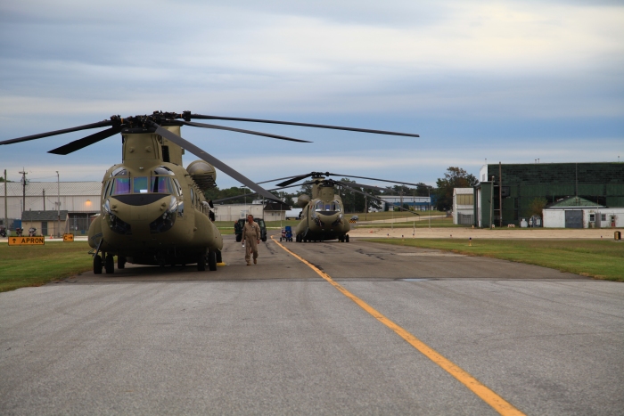 19 September 2012: Flight Engineer Bruce Cain takes one last look at CH-47F Chinook helicopter 10-08807 before takeoff on the aircraft delivery ferry flight from Millville Municipal Airport (KMIV) to Marshall Airfield (KFRI), Fort Riley, Kansas. Sister ship and Chalk Four 10-08806 sits in the background.
