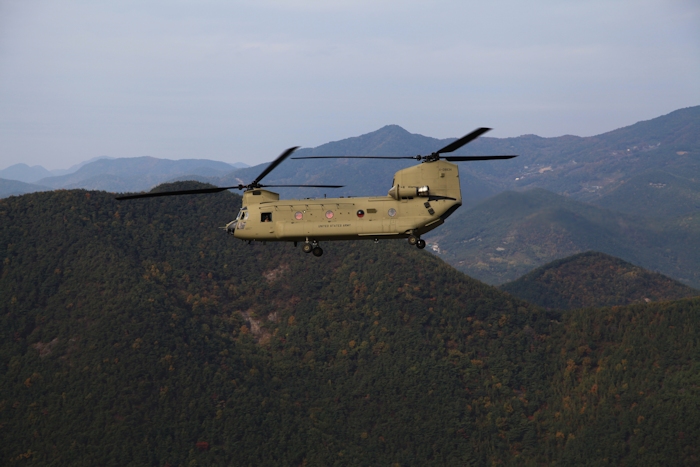 3 November 2013: CH-47F Chinook helicopter 11-08834 enroute to Camp Humphreys during the fielding of the CH-47F fleet in the Republic of Korea. Visible in the left cabin door gunner position is Standardization Instructor Tim Coffman.