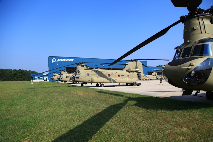 11 September 2013: CH-47F Chinook helicopter 11-08838 rests on the ramp at the Boeing Millville facility, Millville Municipal Airport (KMIV), New Jersey, awaiting movement to the Port of Baltimore for ship transport to the Republic of Korea. CH-47F New Equipment Training Team Instructor Pilot Jason Trombly stands behind the aircraft as an unknown Boeing employee walks by.