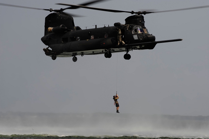 MH-47G Chinook helicopter 05-03756, flown by members of the 160th Special Operations Aviation Regiment (SOAR), conduct rescue winch training at an unknown location. The H-47 winch can lift up to 600 pounds.