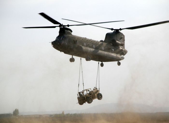 January 24, 2006: A CH-47D Chinook helicopter from the Aviation Support Equipment platoon of the 101st Airborne Division prepares to touch down with a sling-loaded forklift as part of a Downed Aircraft Recovery Team mission in Iraq.