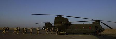 Troops from various units within the 82nd Airborne Division prepare to board a CH-47D Chinook helicopter.