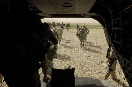 Troops from various units of the 82nd Airborne Division air assault out of the back of a CH-47D Chinook helicopter