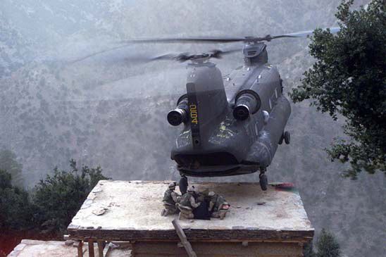 91-00264, a CH-47D, lands on the roof of a house in Afghanistan to pick up suspects during Operation Mountain Resolve, approximately November 2003.