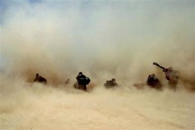 U.S. soldiers shelter from the dust kicked up by a Chinook helicopter as it lands to pick them up from Bagh village, in Khakeran Valley, Zabul province, Afghanistan, June 26, 2005. From U.S. and U.N. officials down to Afghan villagers, there is growing fear that this country may be at a seminal moment with three years of state-building in danger of succumbing to the barrage of violence.