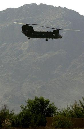 A U.S. Army CH-47D Chinook helicopter flies low to the ground.