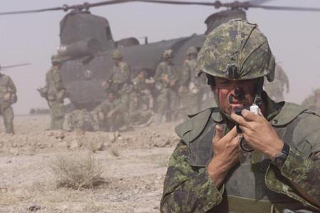 Sgt. Craig Reid of the Third Battalion Princess Patricia's Canadian Light Infantry Battle Group applies camouflage paint.