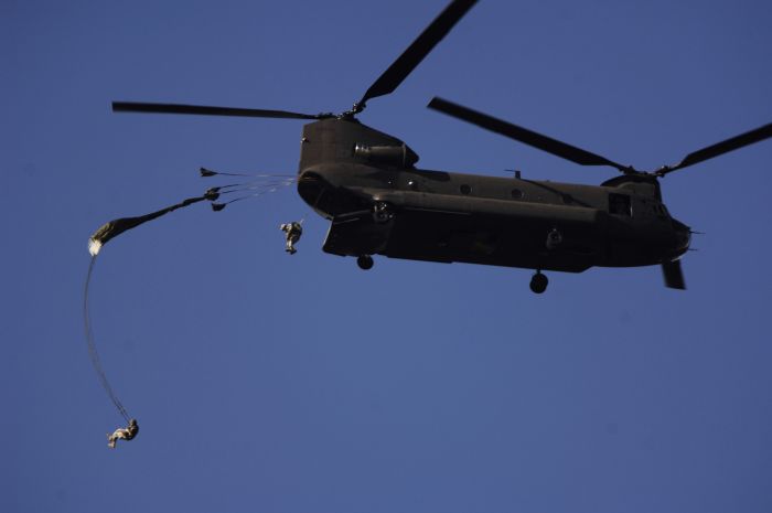 U.S. Army Soldiers jump from a CH-47 Chinook helicopter at McLanely Drop Zone, Fort Lee, Virginia on 7 December 2006. Various units participated in the jump as a quarterly training requirement.
