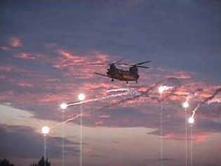 An MH-47E deploys decoy flares.