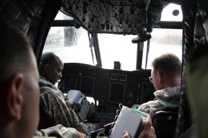 CW4 Ahmad Upshaw (left) from the Directorate of Evaluation and standardization (DES) conducts training in the cockpit of a CH-47F Chinook helicopter.