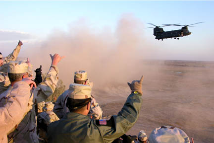 Soldiers of Hawaii Army National Guard's Charlie Company, 193rd Aviation, watch as a CH-47 Chinook cargo helicopter takes off from Balad, Iraq.