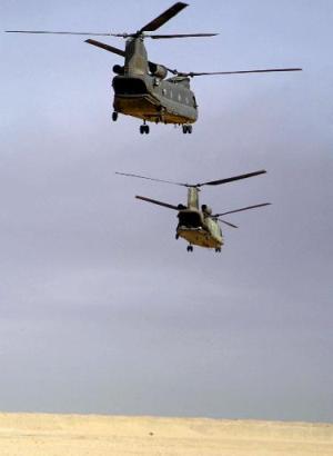 Two CH-47D Chinook helicopters head toward Iraq after taking off from Camp Udairi, Kuwait.