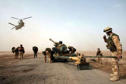 A 105mm gun is dropped by a Chinook helicopter to British 29 Commando Regiment Royal Artillery.
