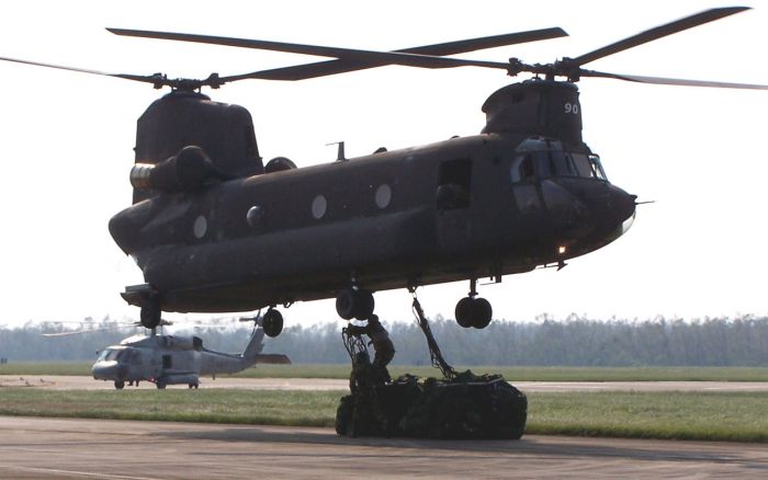 14 September 2005: Soldiers hook pallets of supplies to the underside of a CH-47 Chinook at Naval Air Station New Orleans, so that relief can be delivered to the storm-ravaged city.