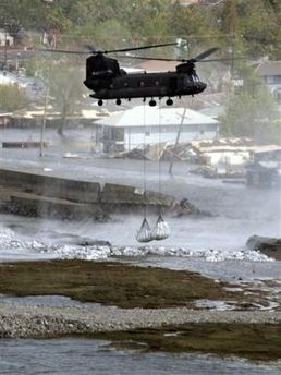 A Chinook helicopter approaches with sandbags to repair the breach in the Industrial Canal levee in New Orleans.