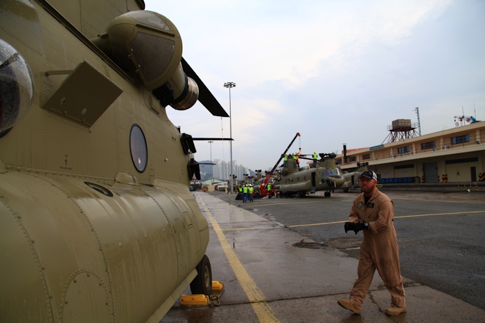 3 November 2013: CH-47F Chinook helicopter Flight Engineer Wade Cothran finishes up preparing a Chinook helicopter for a ferry flight from Pier 8 to Camp Humphreys, Republic of Korea.