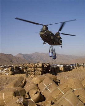 16 November 2005: A Royal Air Force Chinook helicopter flies carrying loads of relief supplies in Muzaffarabad, capital of Pakistan-administered Kashmir. The United Nations and British military launched a huge airlift of food and tents to earthquake survivors high in Pakistan's mountains on Wednesday as Islamabad appealed to the world for more money. Two Royal Air Force Chinook transport helicopters hovered low over an air strip on the outskirts of the ruined city of Muzaffarabad while a British military team on the ground hooked up nets filled with the first of hundreds of tonnes of supplies.