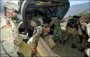 Pakistani soldiers unload relief goods from a US helicopter in earthquake-hit Balakot, in Pakistan's North West Frontier Province. The US military said its helicopters resumed aid deliveries to Pakistani quake victims but were avoiding an area where one of its Chinooks came under suspected rocket fire in Kashmir.