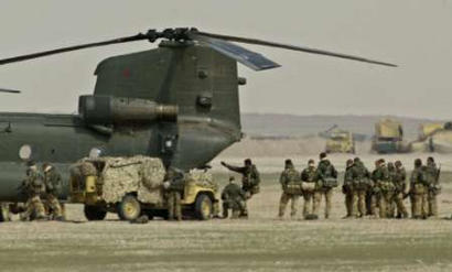Preparing for a possible declaration of war against Iraq, troops train boarding a Chinook helicopter.