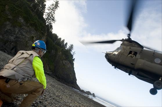 Doug Cameron waits for the CH-47D Chinook helicopter to land on the beach.