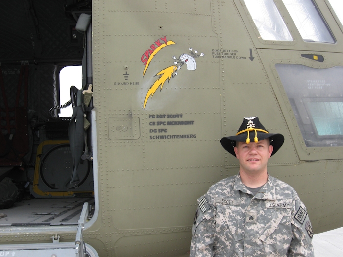 SGT Sidney Scott, Flight Engineer of 08-08056, poses beside his aircraft while it was assigned to B Company, 6-6 CAV in theater.
