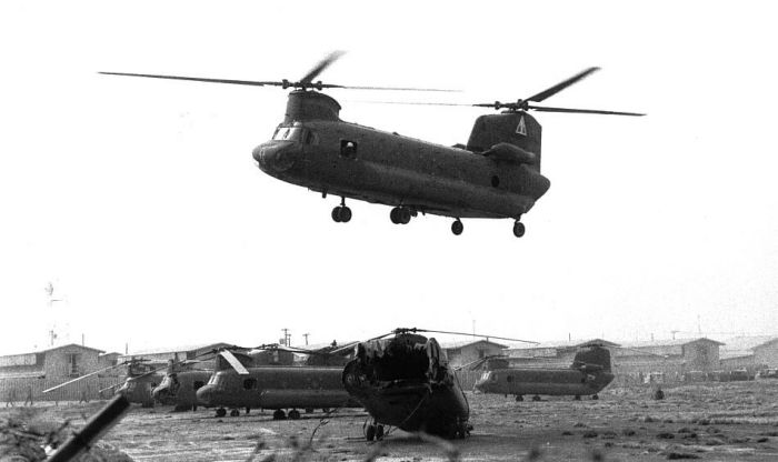 CH-47B Chinook 67-18476 bringing a destroyed sister ship onto the helipad at Tan Son Nhut airbase in Saigon, in the Republic of Vietnam (RVN), circa 1969.