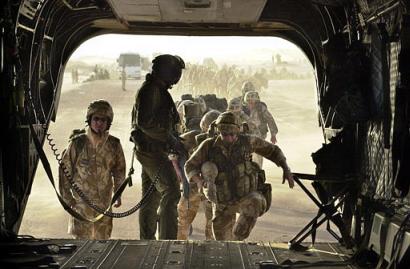 Members of Charlie and Delta Company of 40 Commando British Royal Marines board a Chinook helicopter.