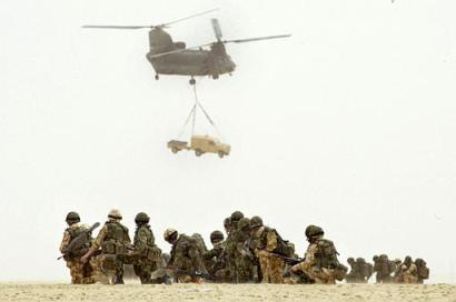 British soldiers of 51 Squadron, Royal Air Force, look at an RAF Chinook.
